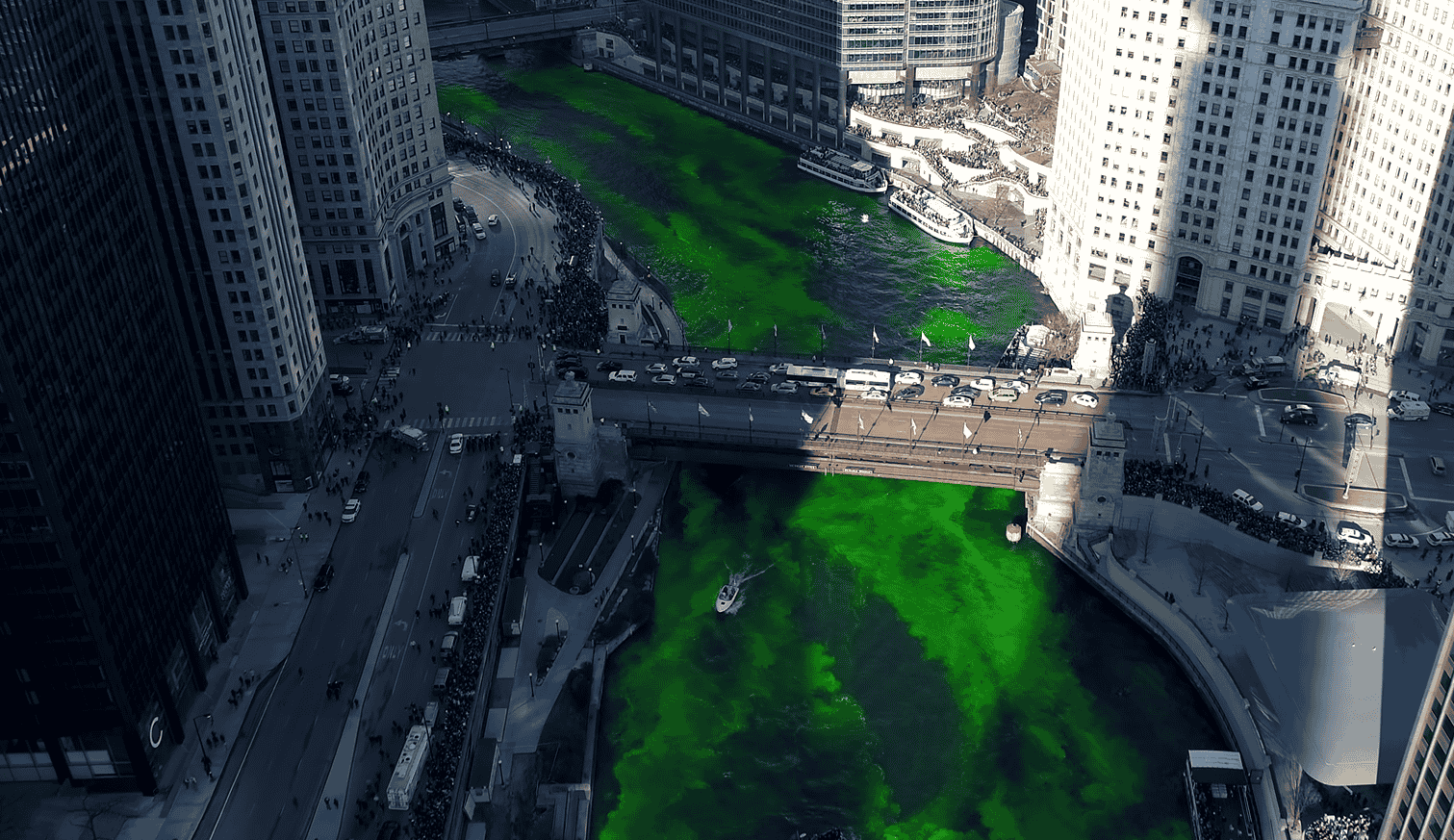 Crowds gathered on Michigan Avenue Bridge watching the Chicago River turn green on St. Patrick’s Day