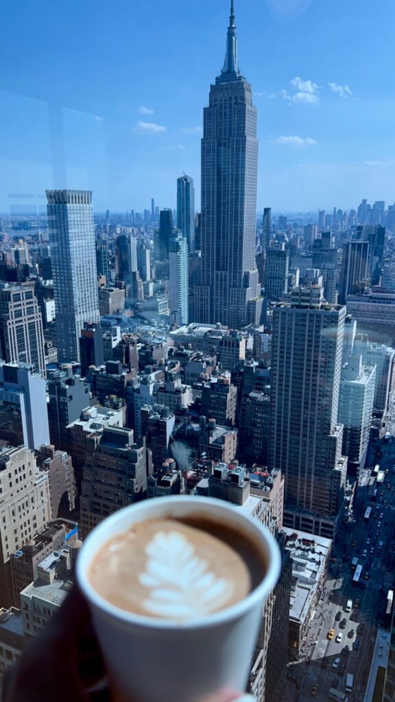 Cup of coffee with Manhattan skyline view and Empire State Building in New York City