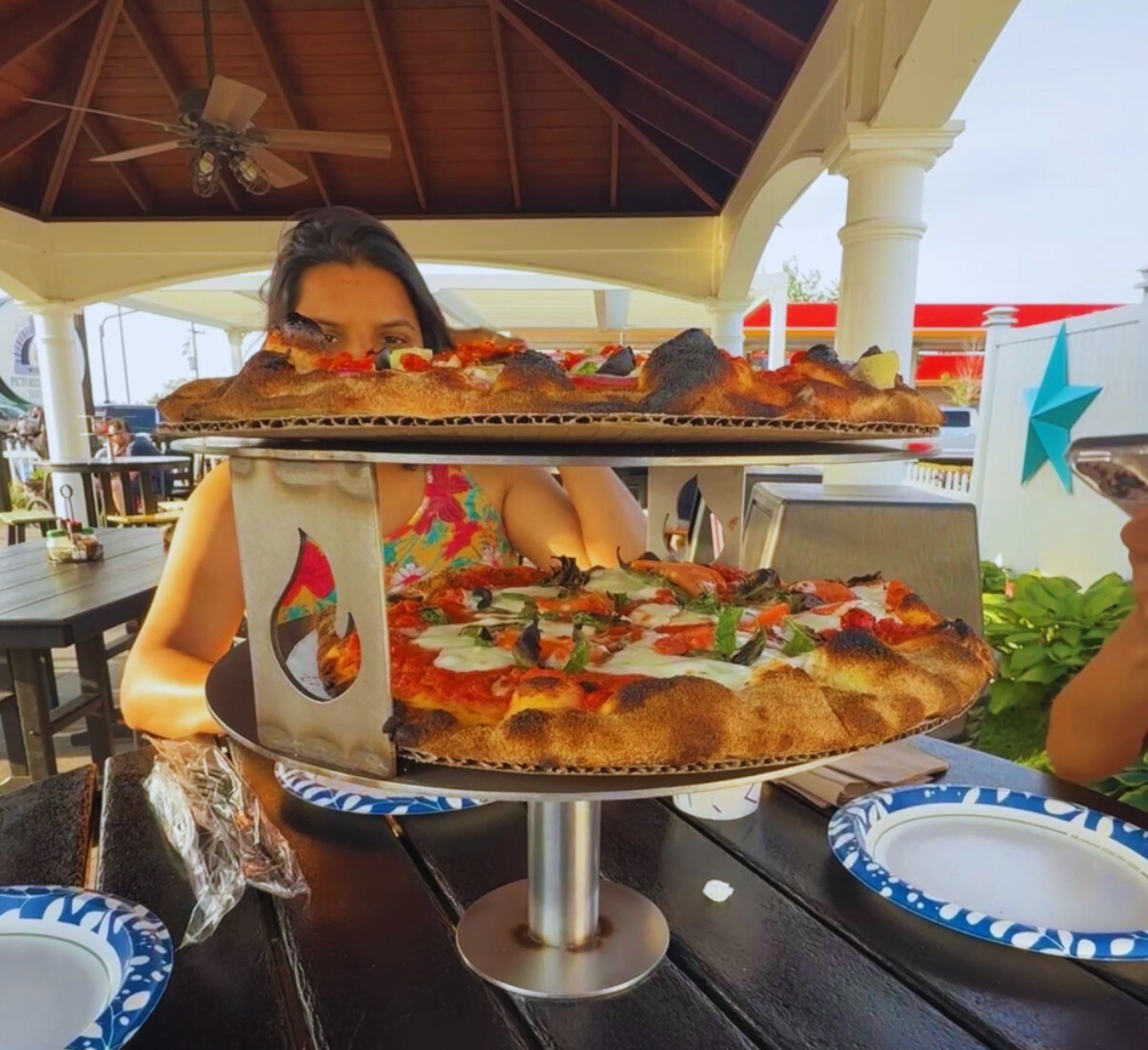 Freshly baked pizza on a wooden board at Pictured Rocks Pizza restaurant.