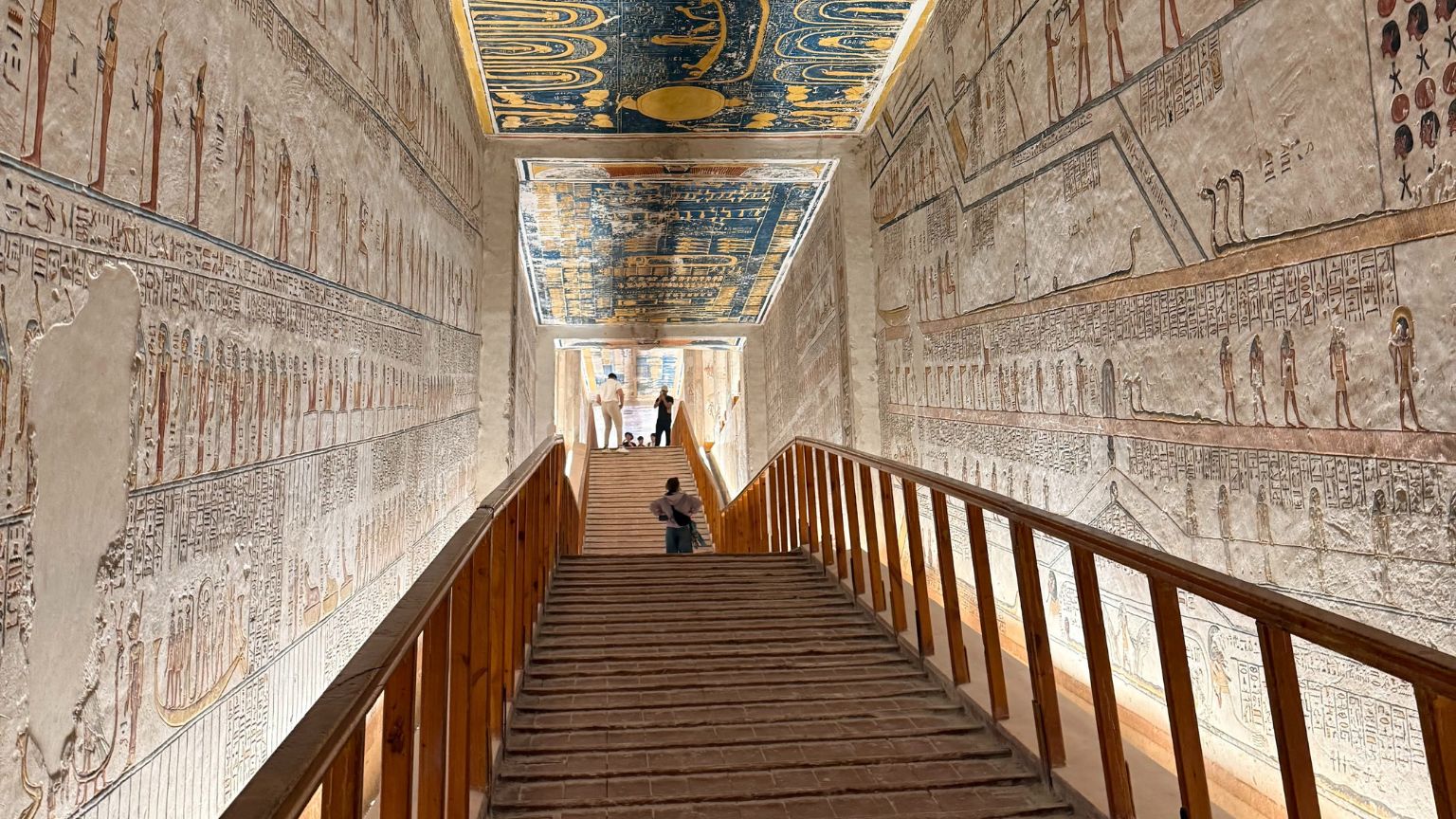 Inside Valley of the Kings tomb showing painted walls and famous blue ceiling, Luxor Egypt