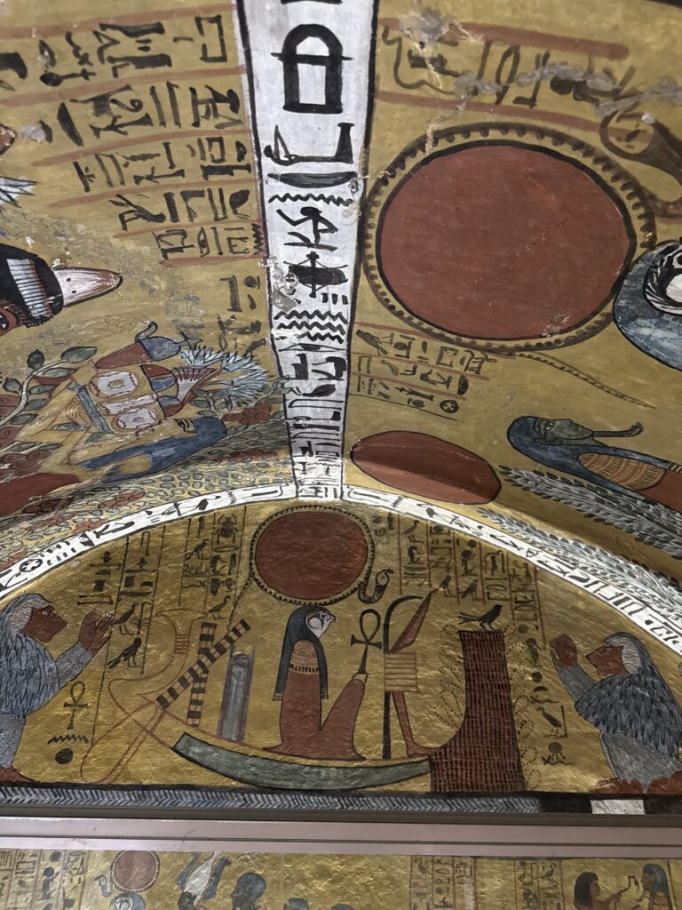 Egyptian scarab beetle and sun god artwork on vaulted tomb ceiling at Deir el-Medina