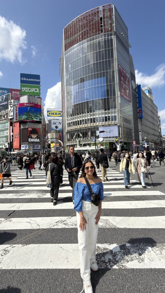 Curved glass QFRONT building with a large Coca-Cola advertisement above Shibuya Crossing, Tokyo