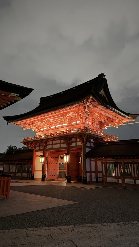Illuminated Romon gate at Fushimi Inari Taisha, Kyoto, glowing at night